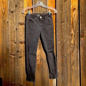 Girl’s black ripped jeans